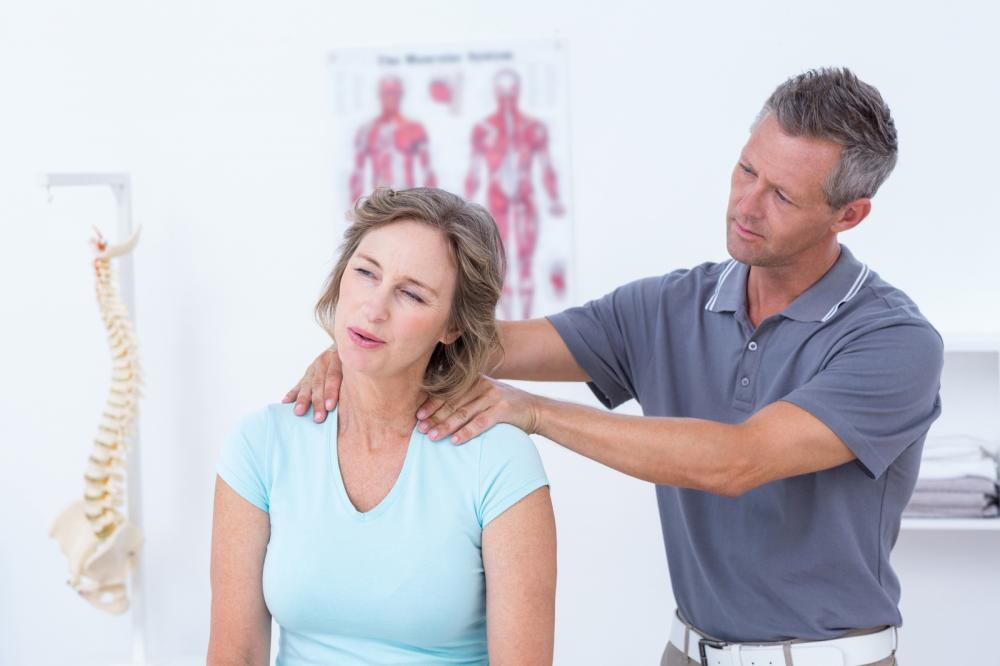 doctor massaging patient shoulders